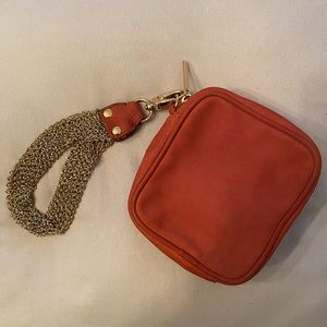 Uterque brand orange suede wristlet with gold tone chain wrist strap